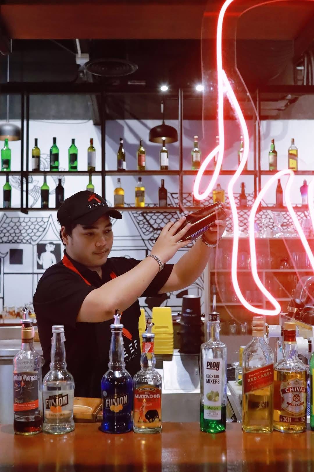 Bartender preparing drinks at X BEEF