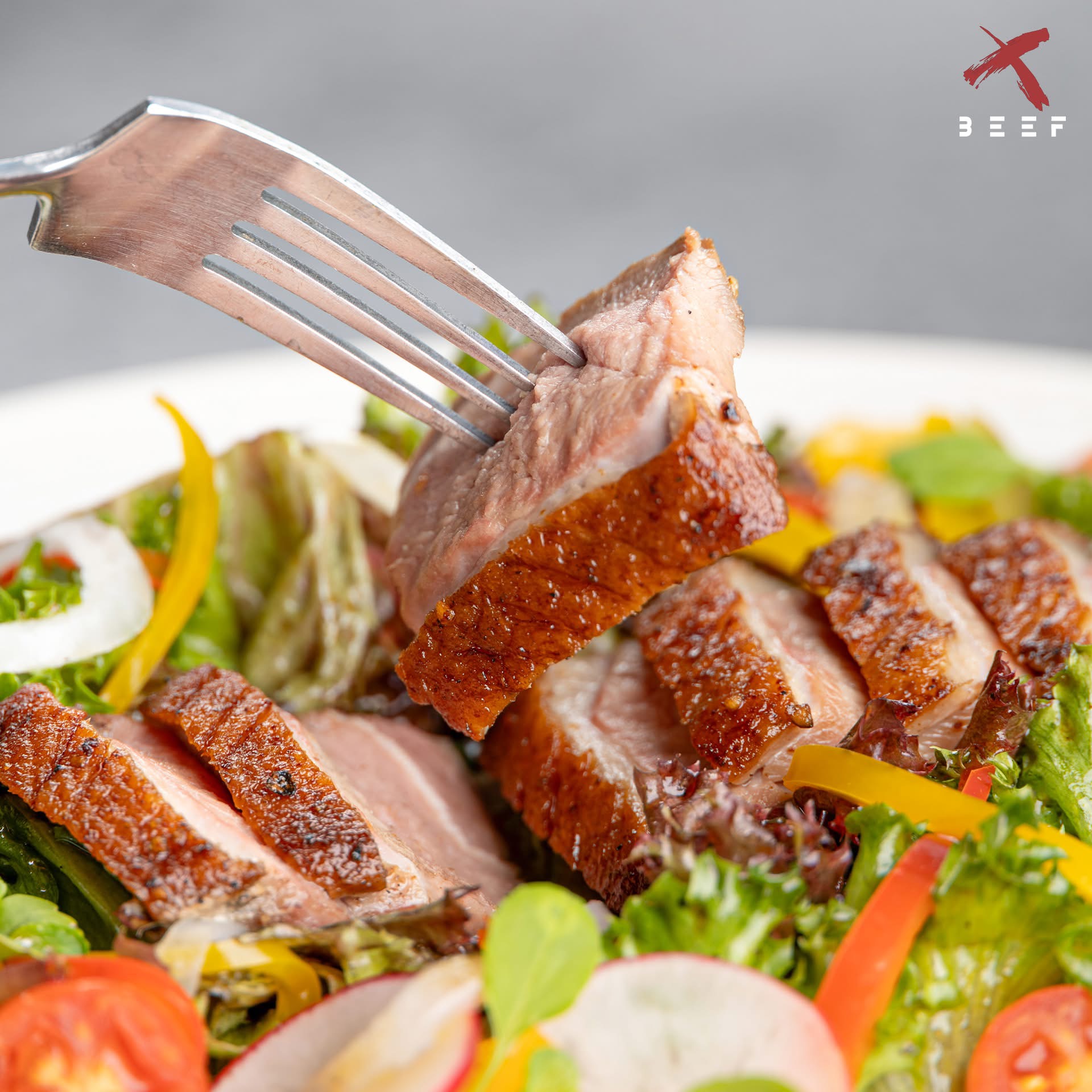 Roasted duck salad close up at X BEEF